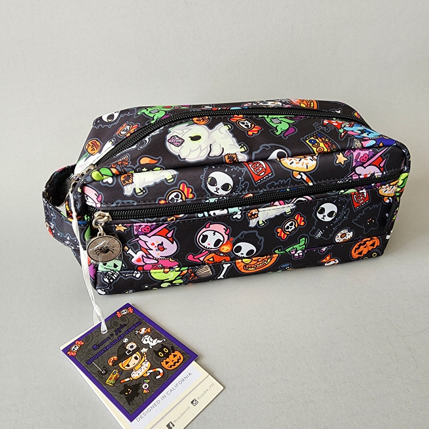 small zippered pouch with Halloween-themed design on a black background