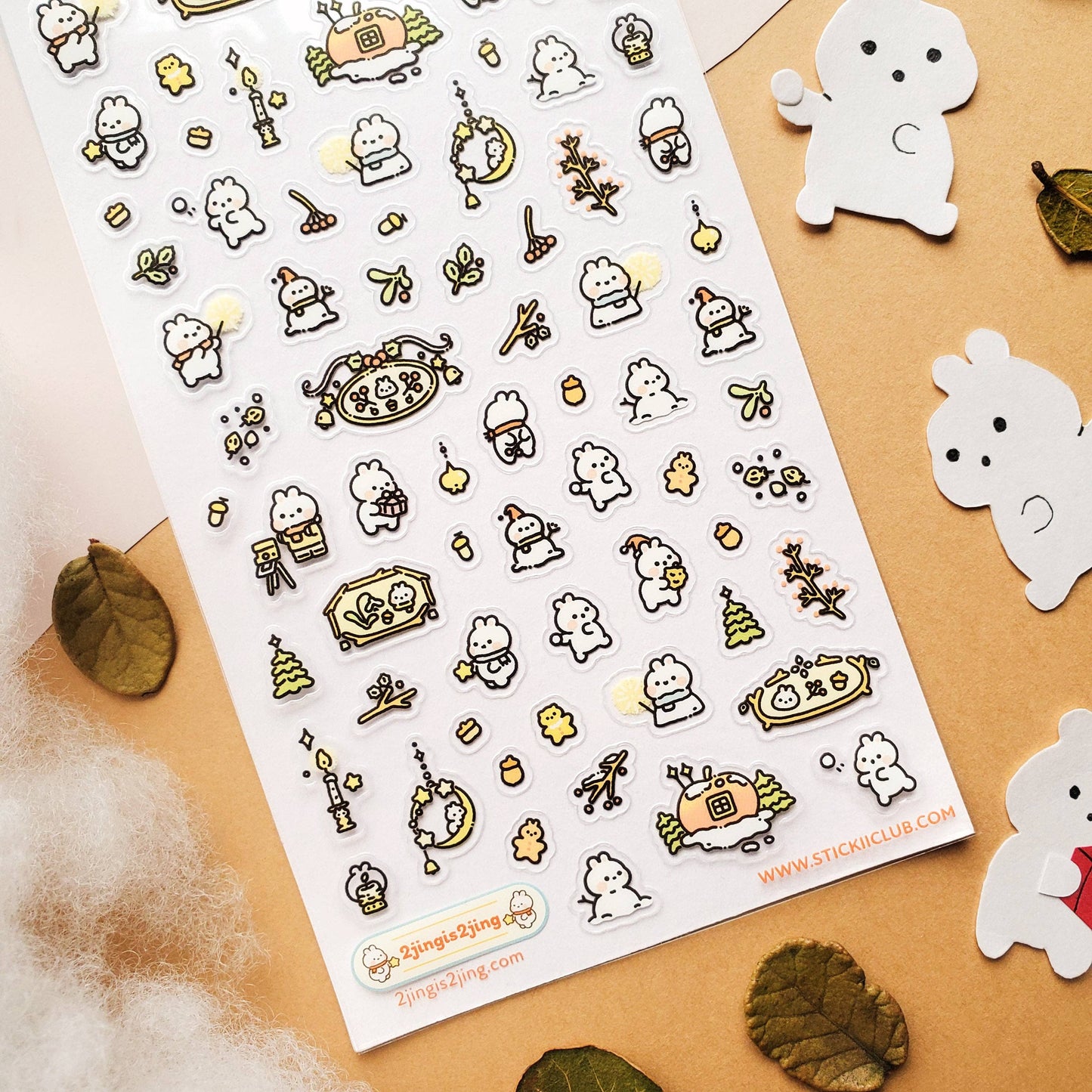 Sheet of cute character stickers with a decorative border on a beige background.