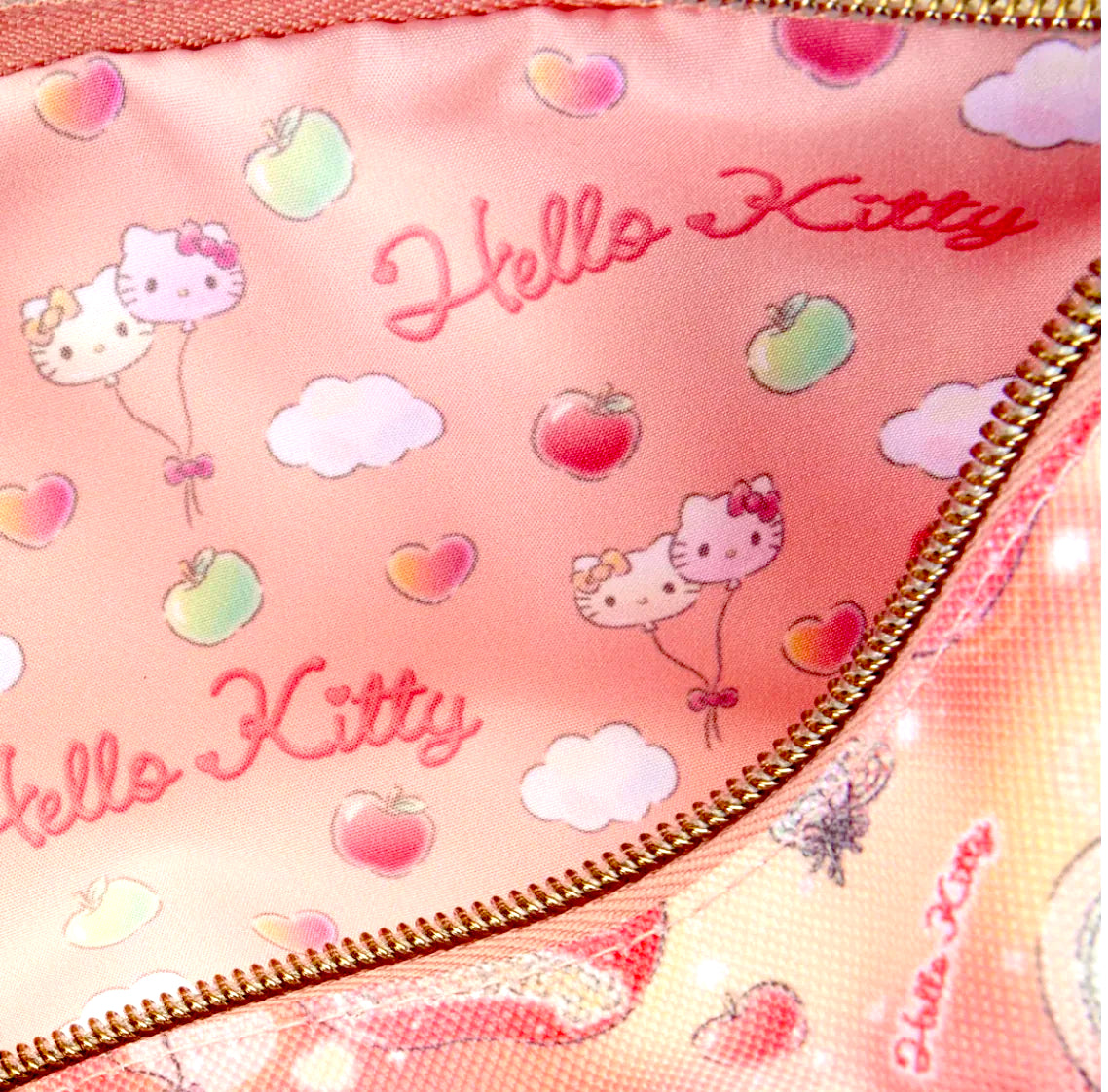 Pink pouch with Hello Kitty design featuring cartoon characters, apples, and clouds.
