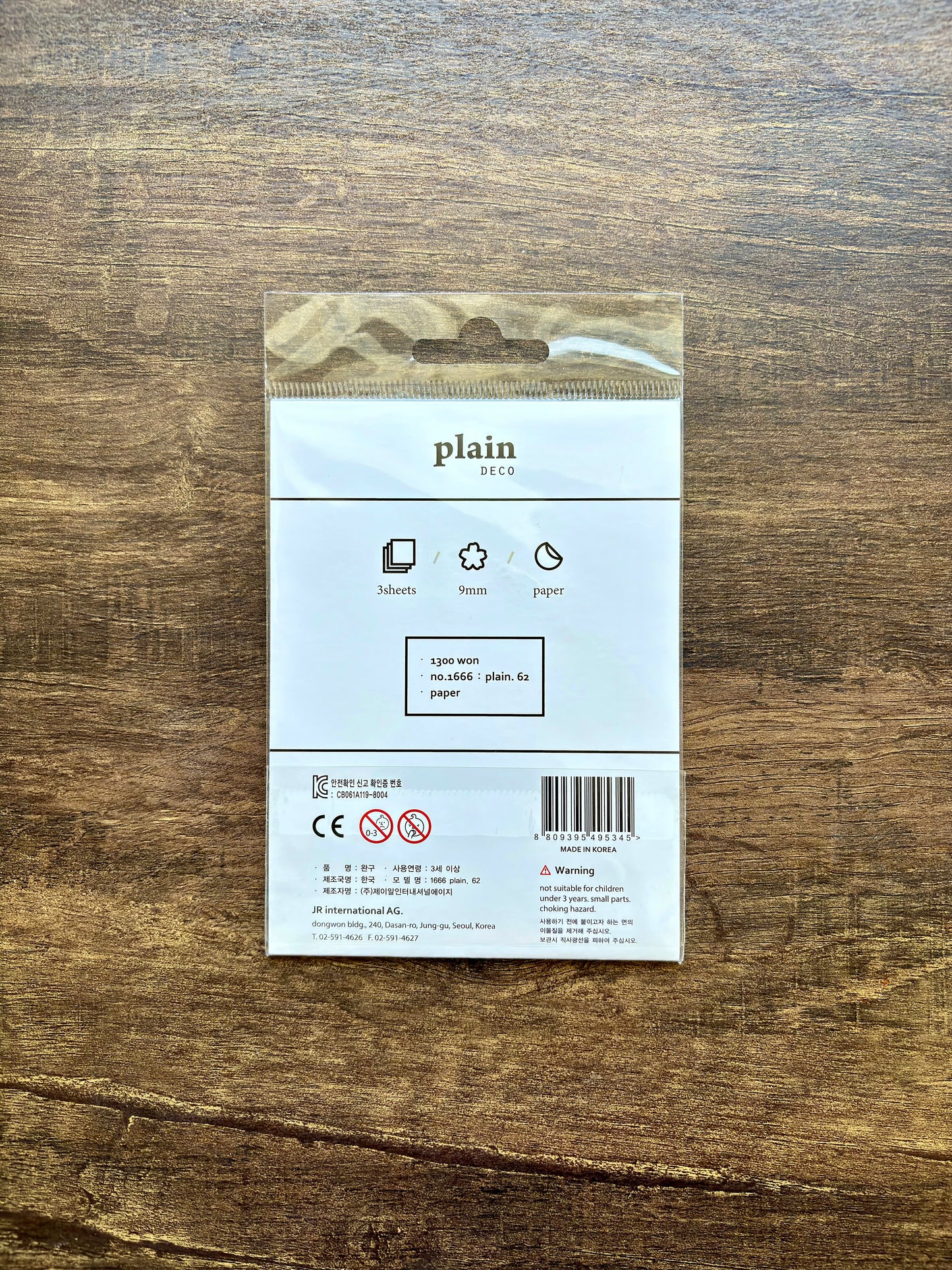 Product packaging with 'plain' branding on a wooden surface