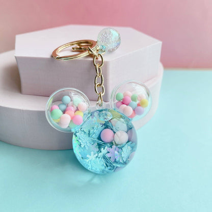 Decorative keychain with colorful beads and a pink background