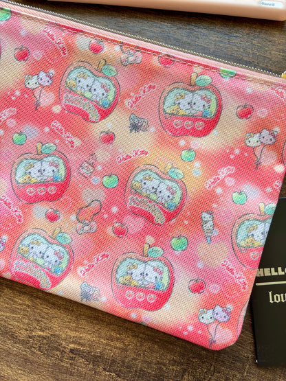 Hello Kitty pouch with apple design on a wooden surface