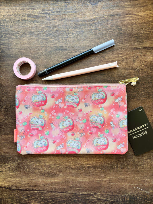 Pink pouch with Hello Kitty design, pen, tape, and card on a wooden surface