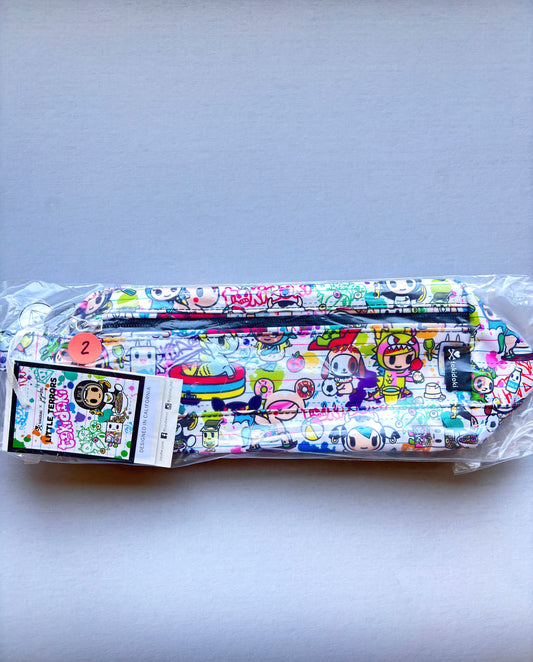 Packaged colorful face masks with cartoon designs on a light gray background
