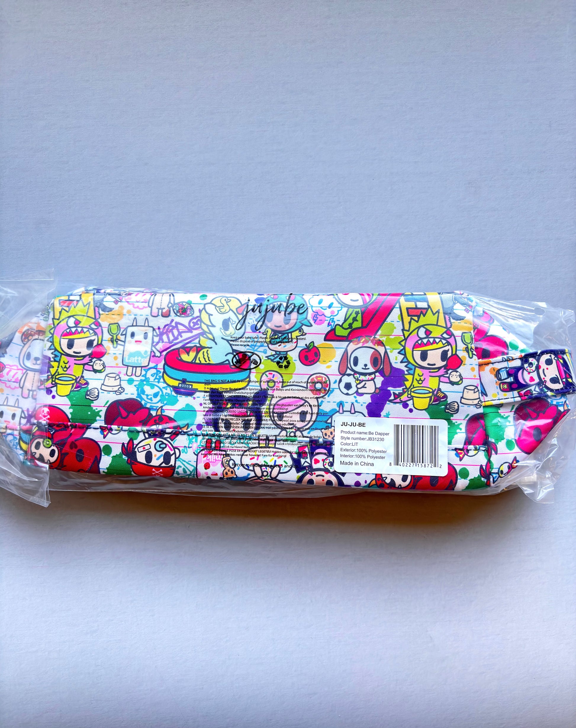Colorful mask with cartoon character design in packaging on a light gray background