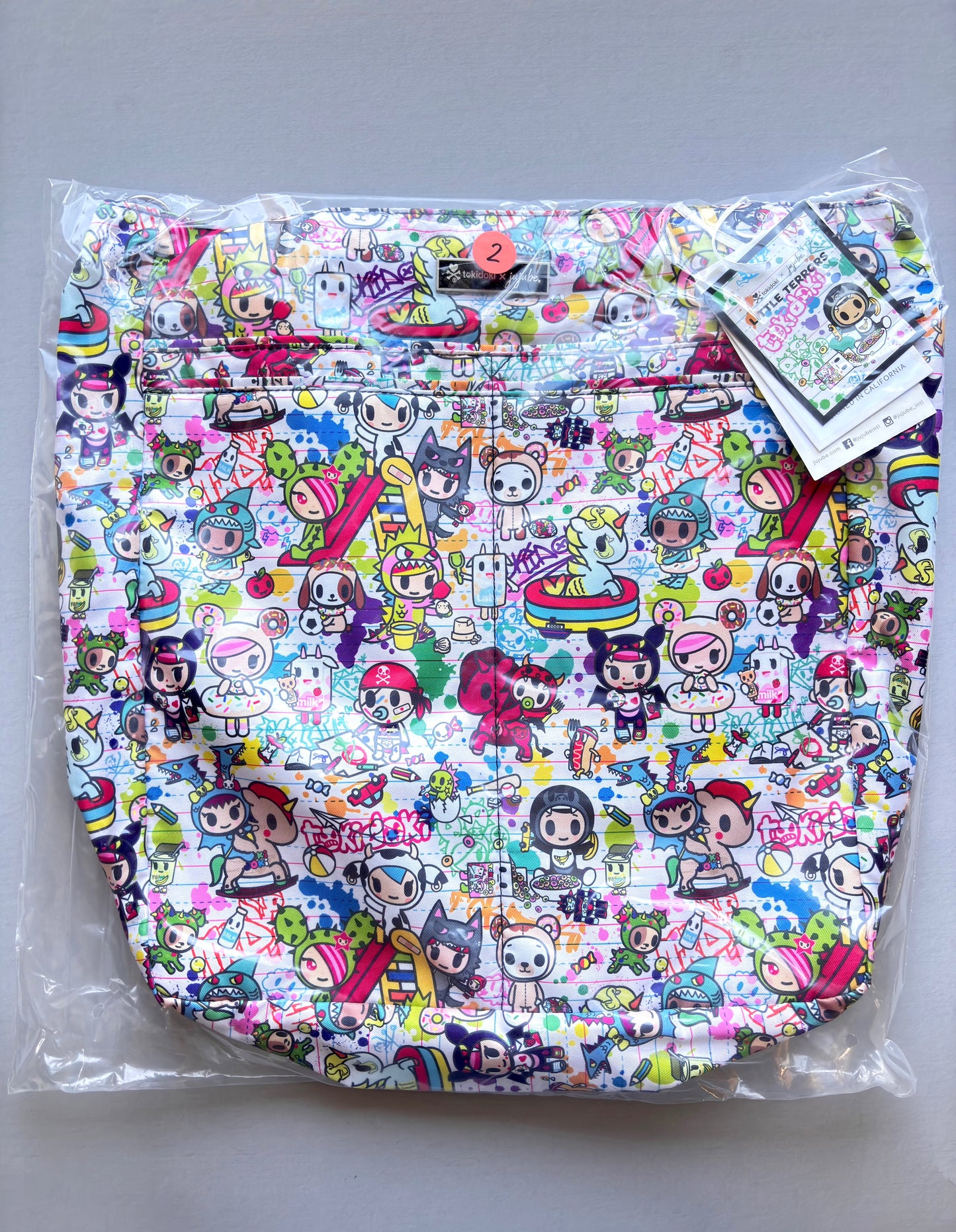 Colorful patterned bag with cartoon characters on a gray background