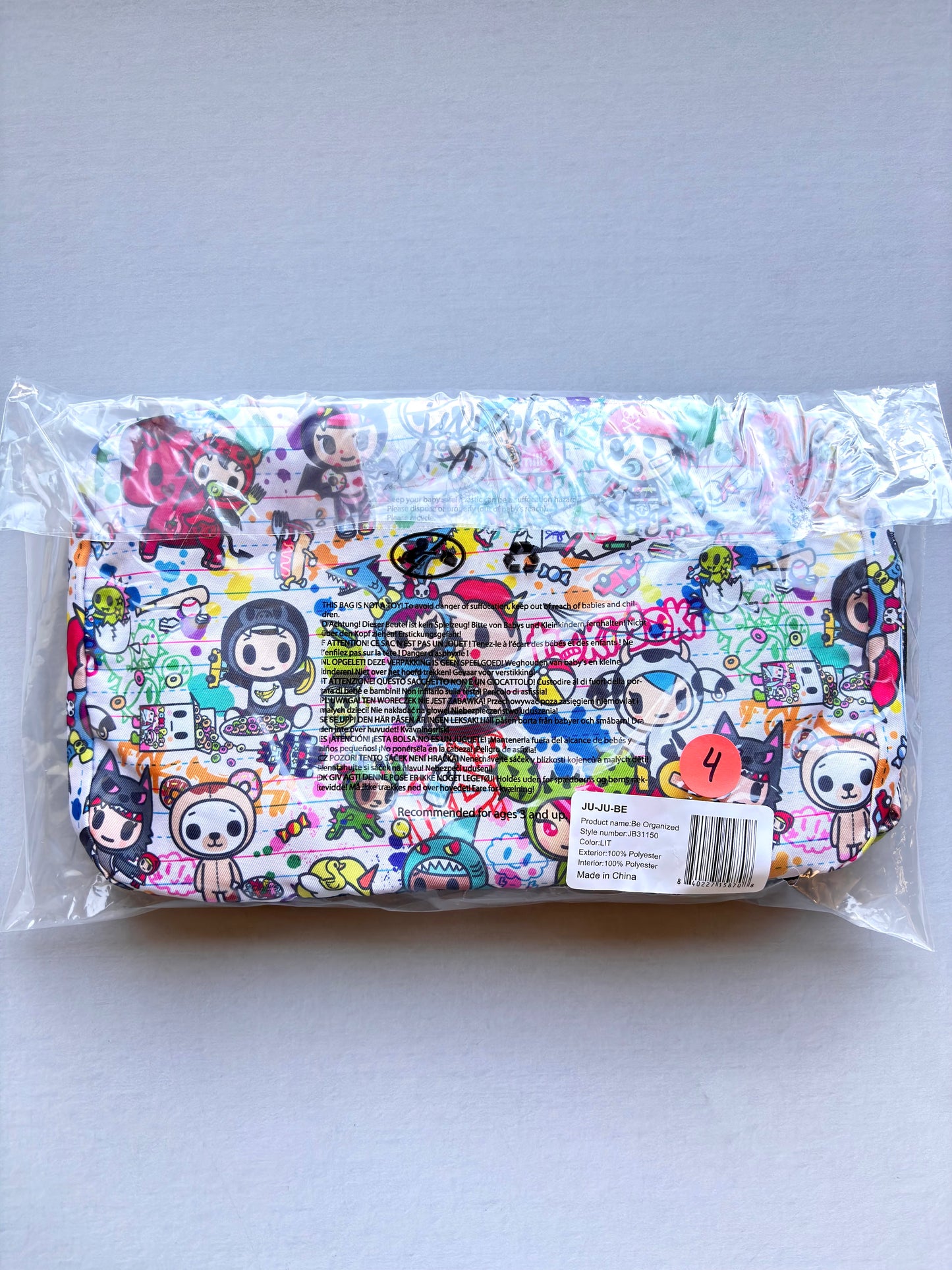 Colorful pouch with cartoon character design in clear packaging on a white background
