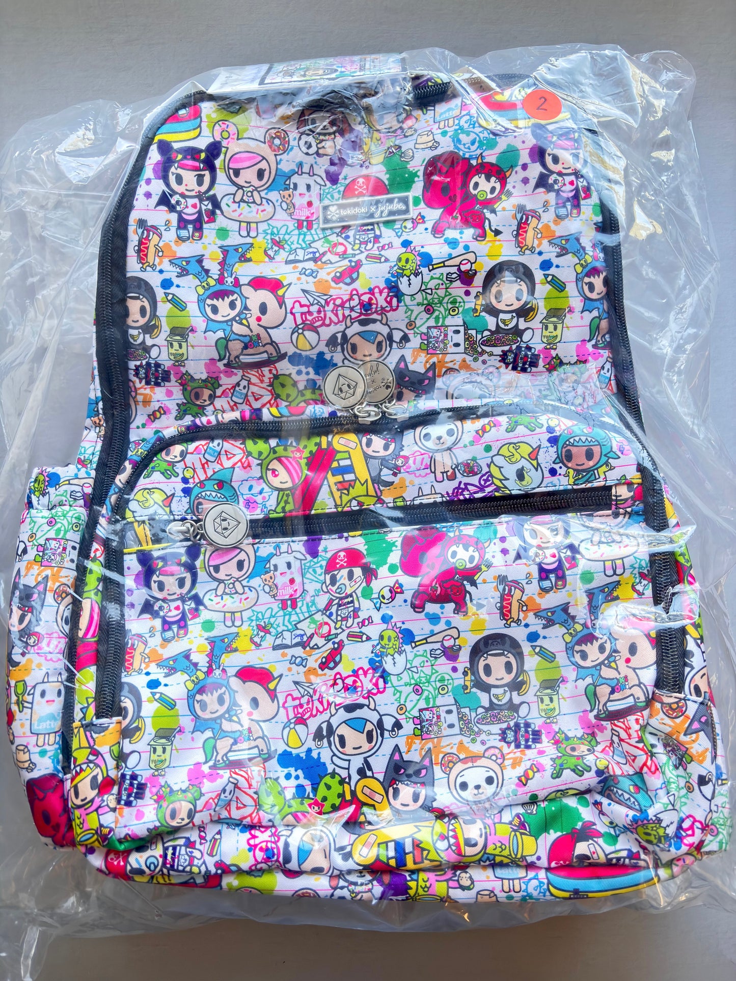 Colorful backpack with cartoon character pattern on a clear background