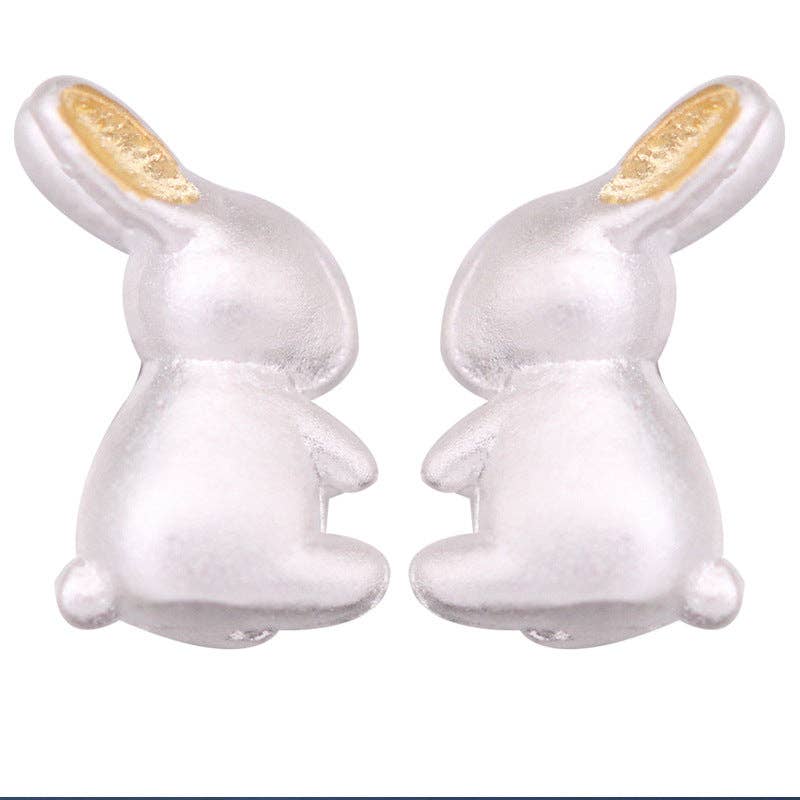 Silver bunny-shaped earrings on a white background