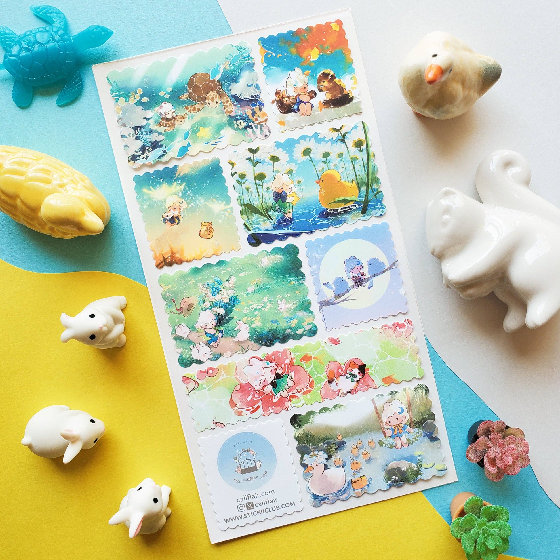 Sheet of colorful scenic stickers with cartoon characters on a blue and yellow background with small animal figurines.