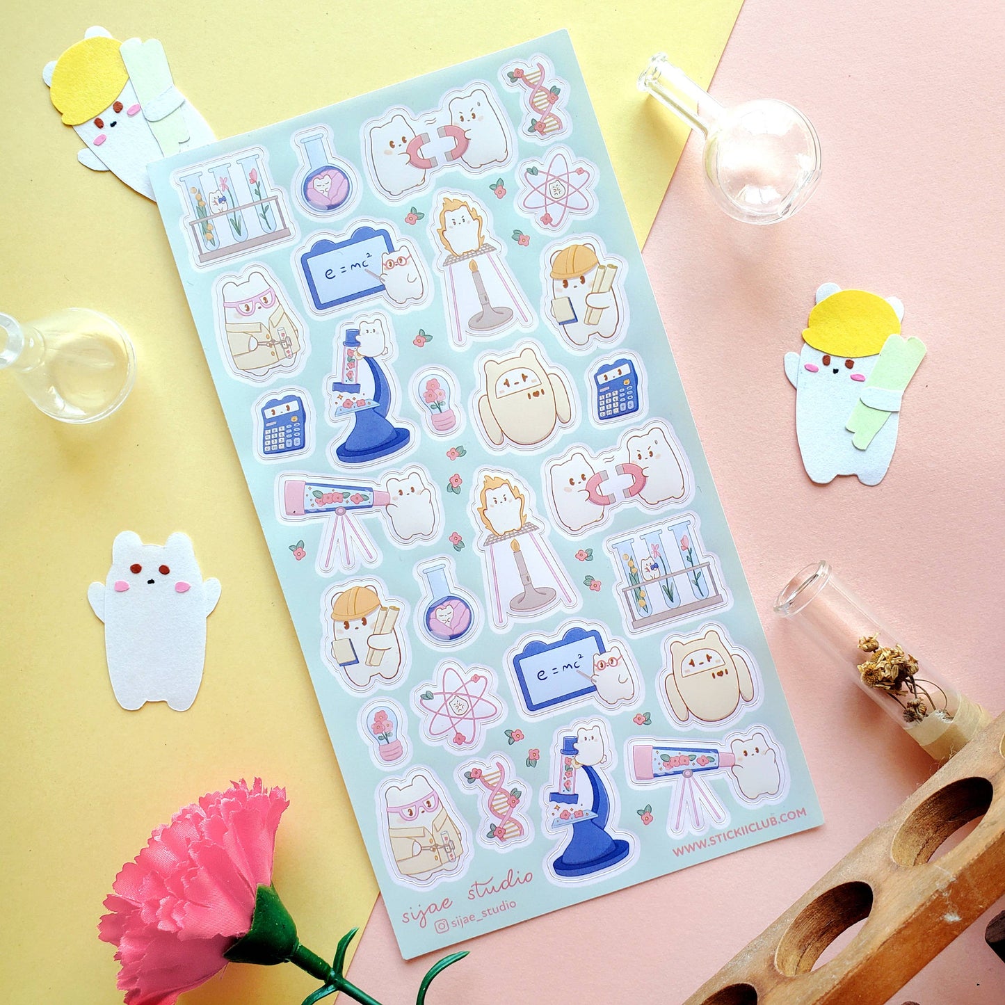 Sheet of cute cartoon science stickers on a colorful background with small decorative items.