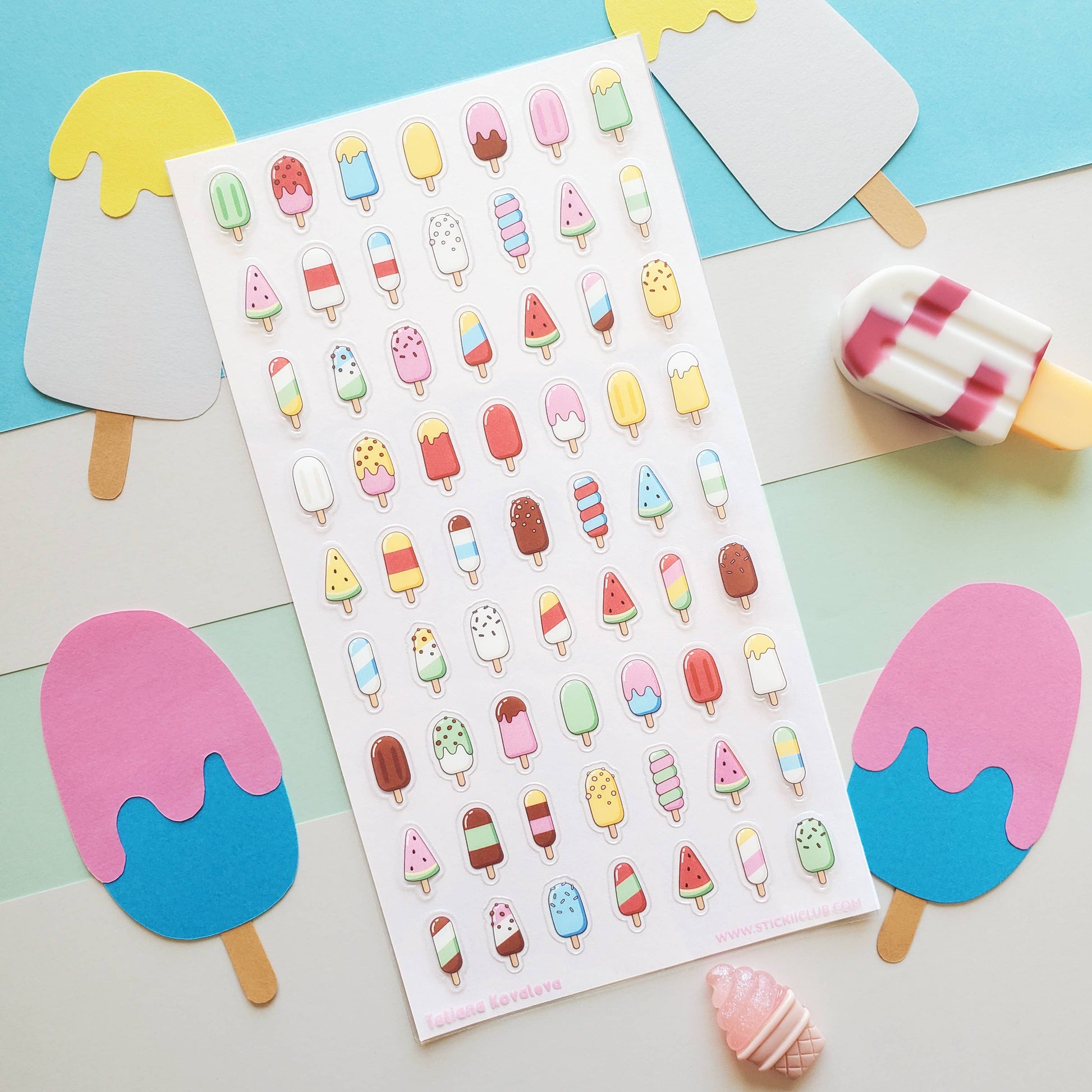 Sheet of colorful ice cream sticker sheet on a pastel background with actual ice cream sticks.