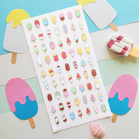 Sheet of colorful ice cream sticker sheet on a pastel background with actual ice cream sticks.