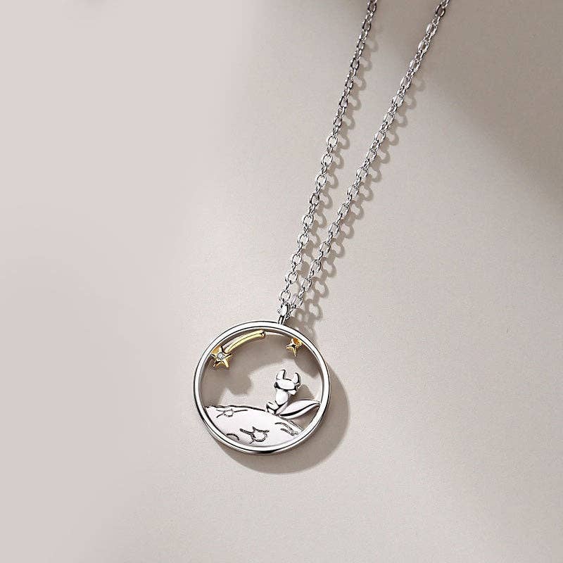 Silver necklace with a round fox pendant on a light gray background