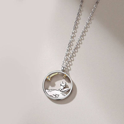 Silver necklace with a round fox pendant on a light gray background