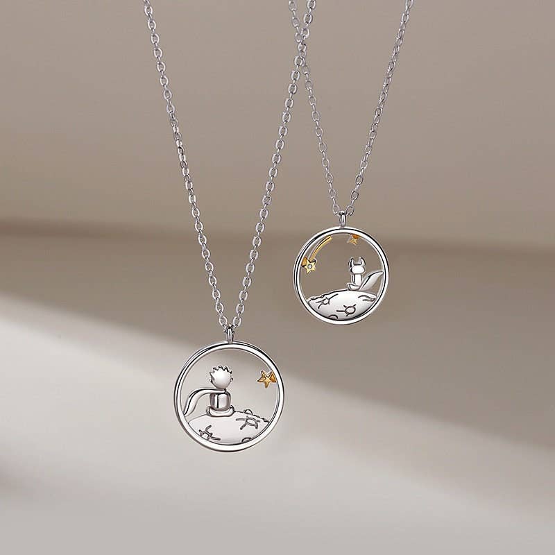 Two silver necklaces with circular pendants on a beige background