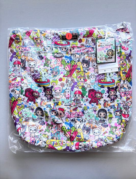 Colorful cartoon-patterned product in clear packaging on a gray background