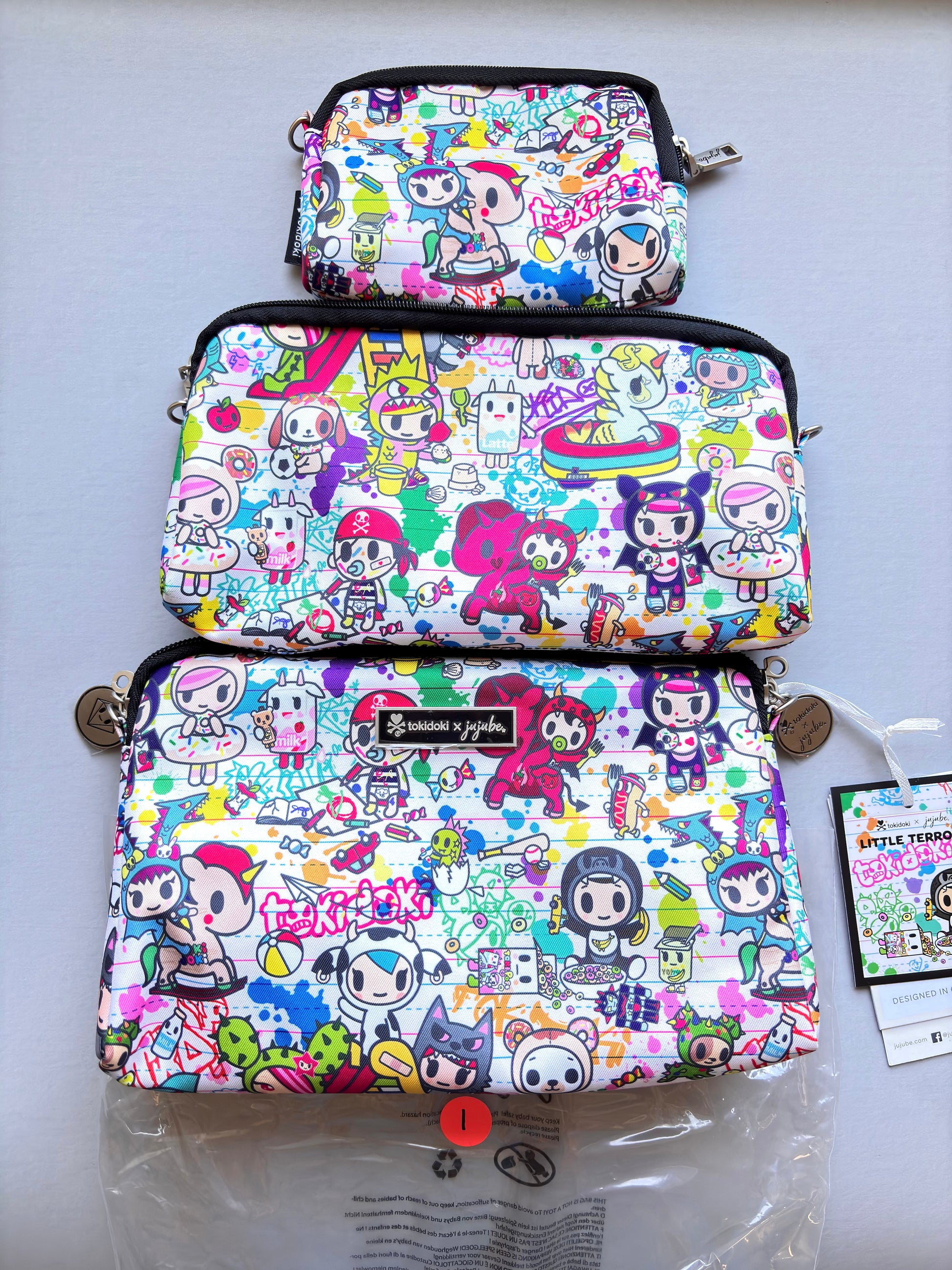 Three colorful pouches with cartoon character pattern on a white surface