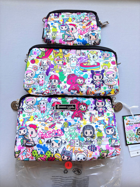 Three colorful pouches with cartoon character pattern on a white surface