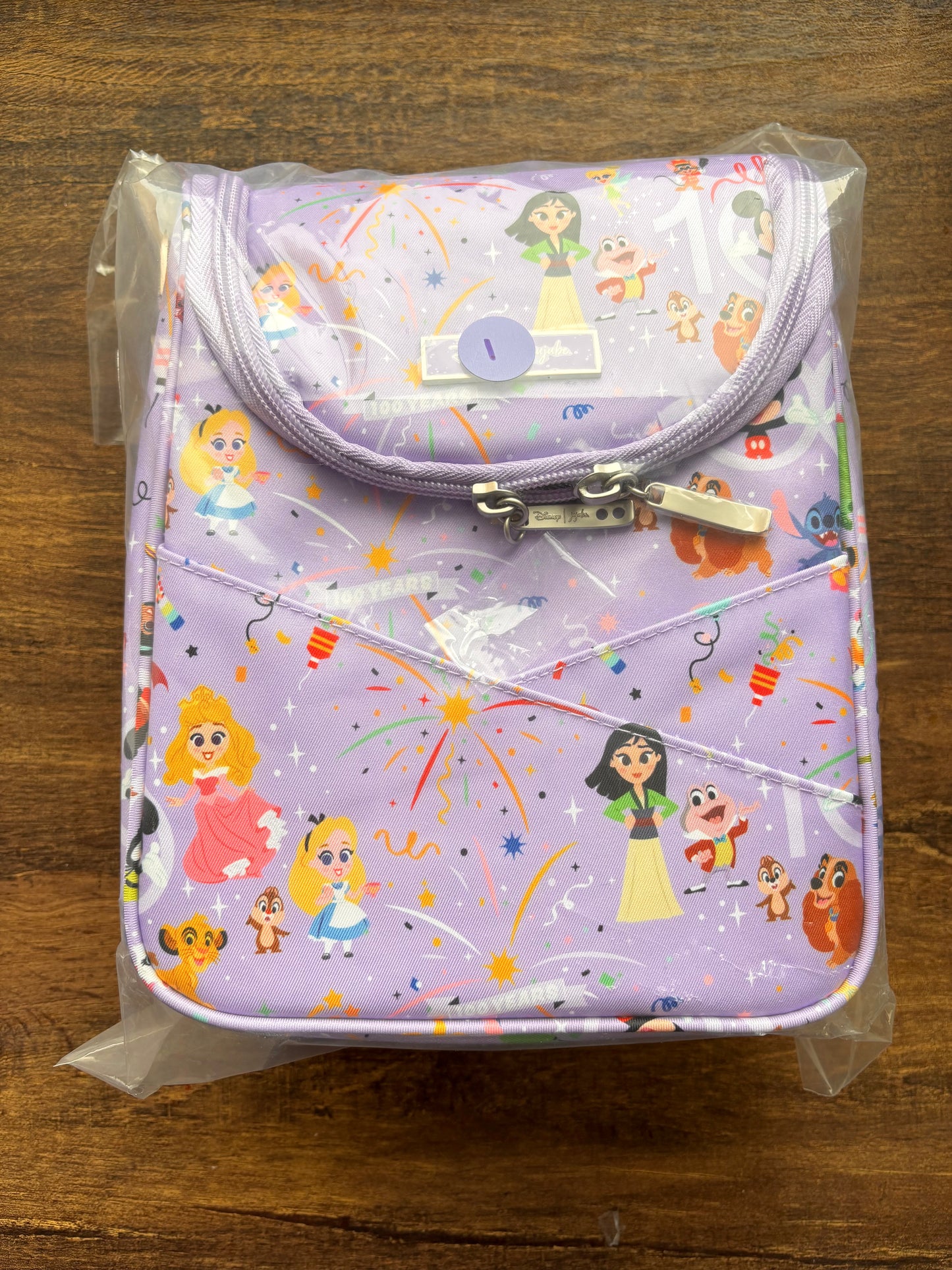 Disney insulated bag with cartoon character print on a wooden surface