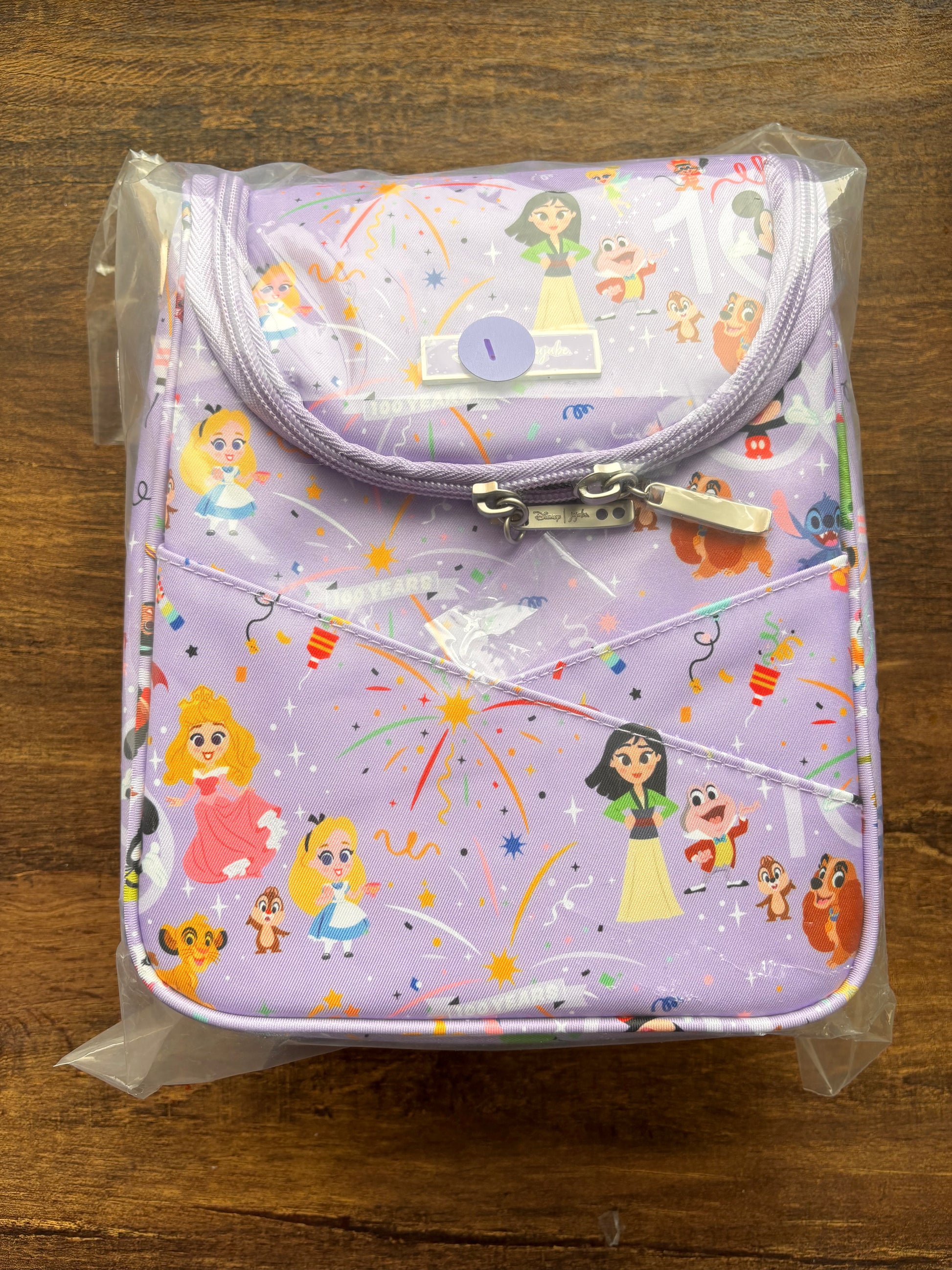 Disney insulated bag with cartoon character print on a wooden surface