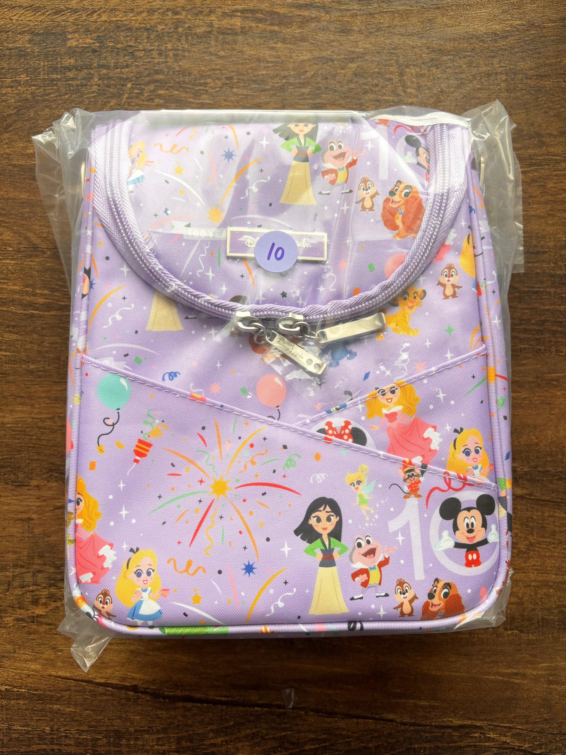 Children's lunch bag with cartoon character print on a wooden surface