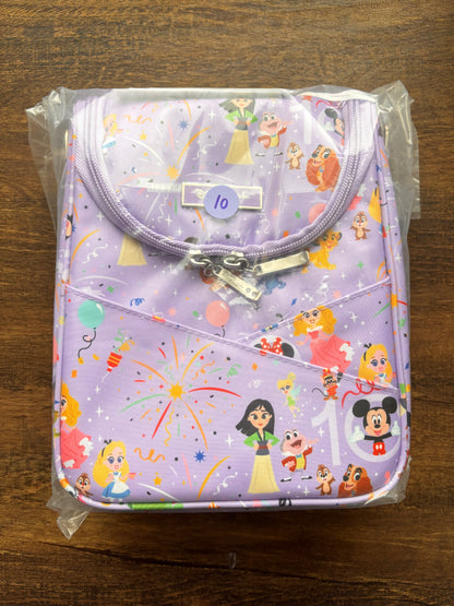 Children's lunch bag with cartoon character print on a wooden surface