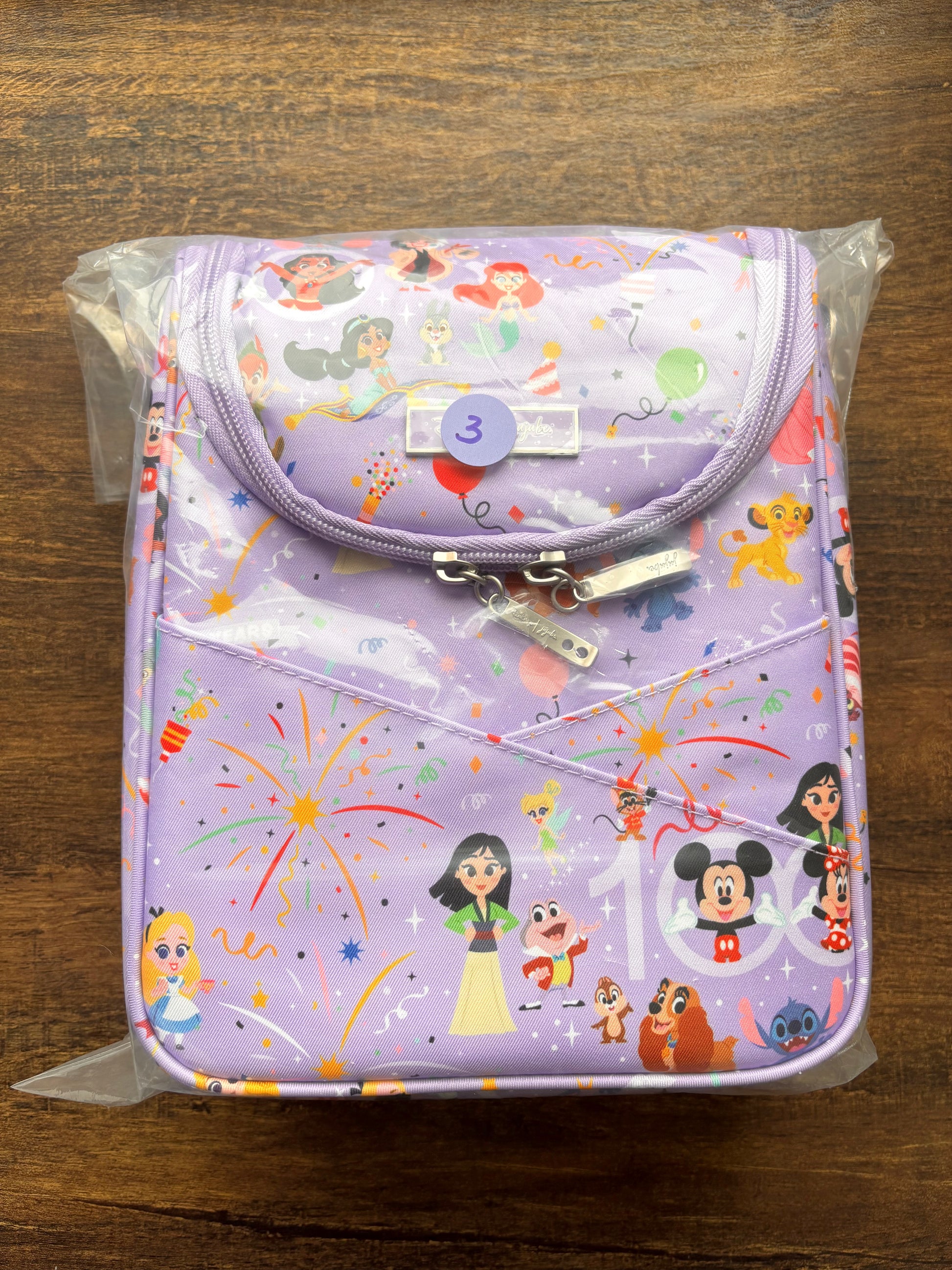 Insulated bottle bag with DIsney cartoon character design on a wooden surface