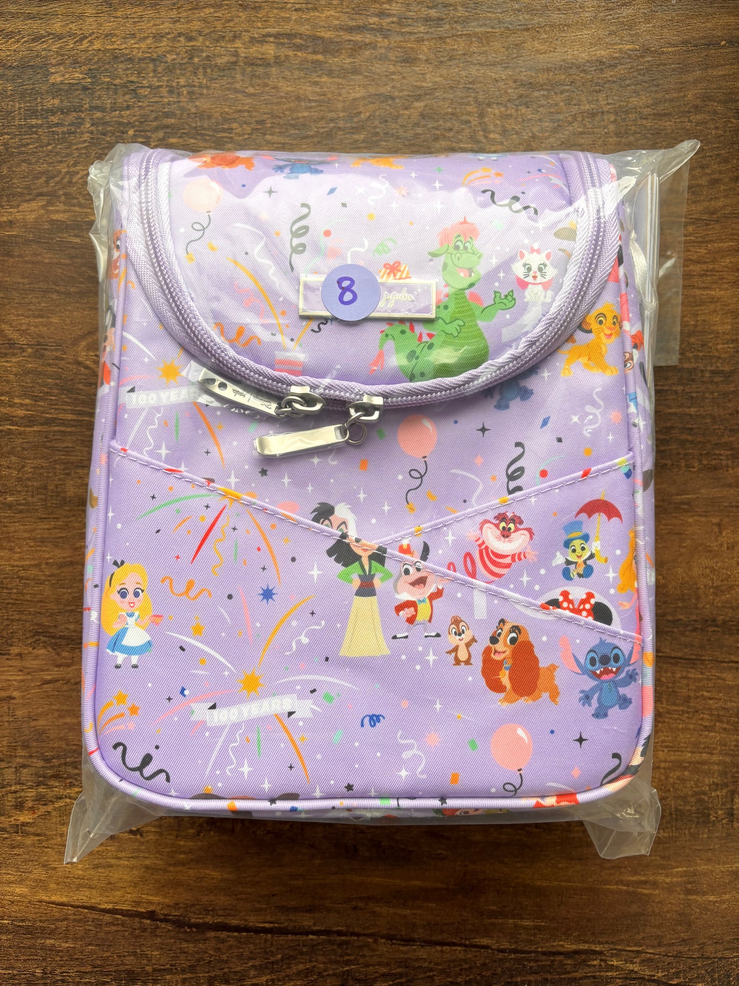 DIsney lunch bag with cartoon characters on a wooden surface