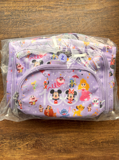 Disney-themed pouch in clear plastic packaging on a wooden surface