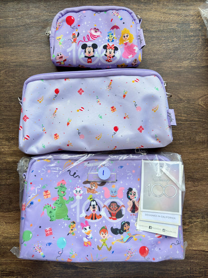 Three purple pouches with Disney cartoon character designs on a wooden surface.