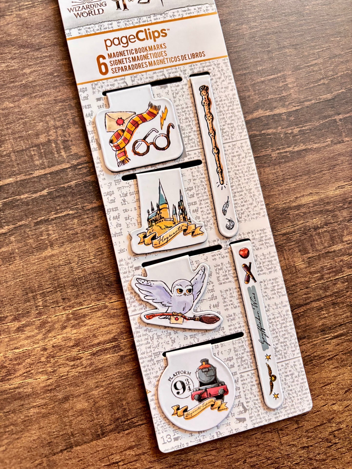 Set of magnetic bookmarks with Harry Potter design on a wooden surface