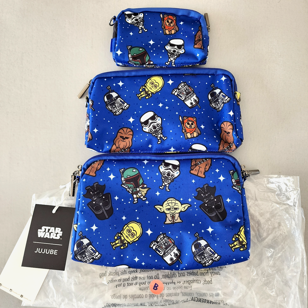 Three blue pouches with Star Wars character patterns on a beige background