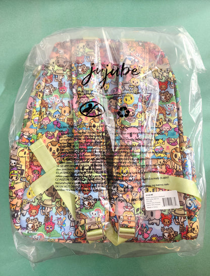 Colorful backpack with cartoon character pattern in clear plastic packaging on a green background