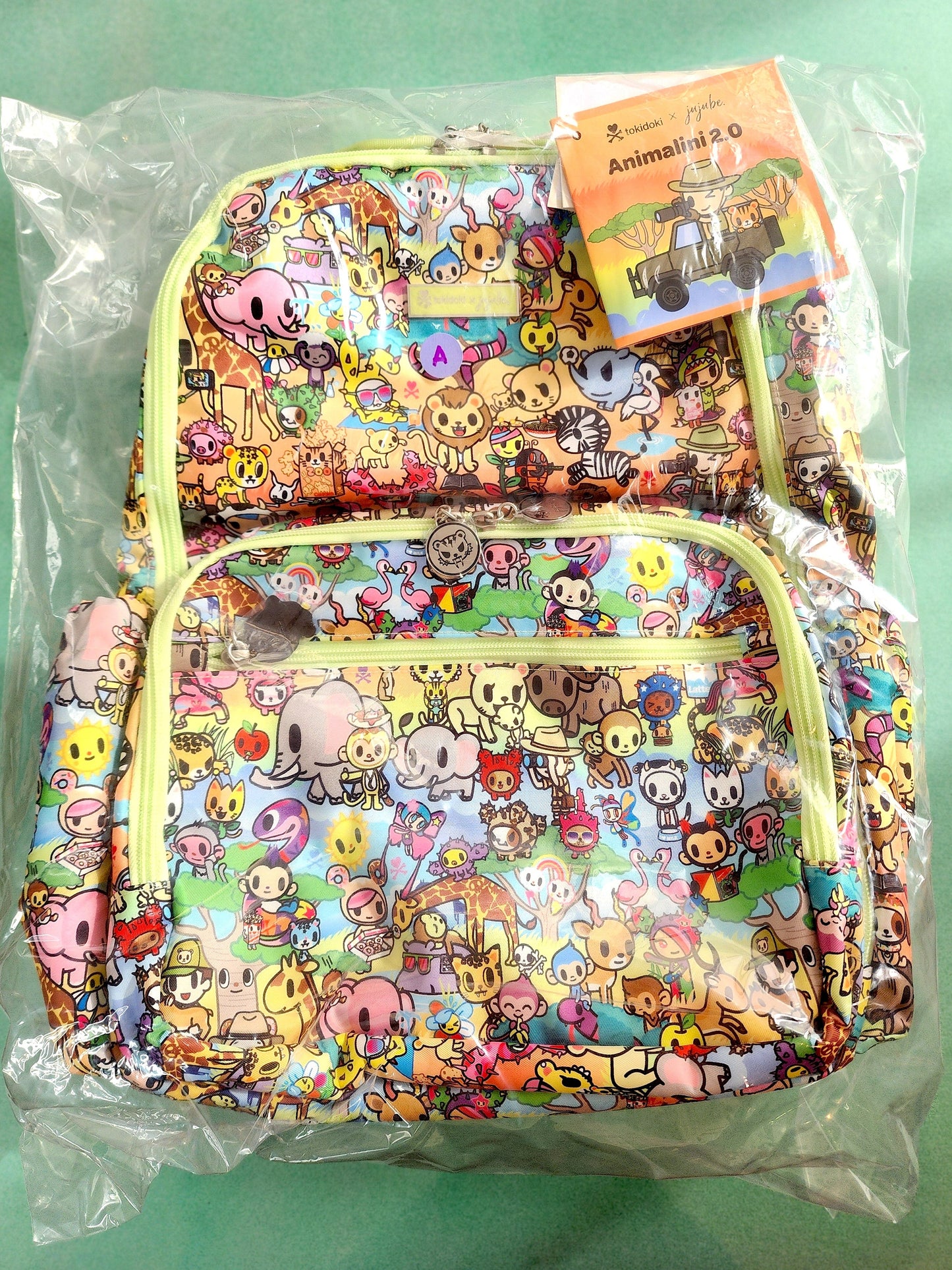 Colorful backpack with cartoon character pattern on a green background