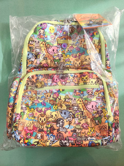 Colorful backpack with animal pattern in clear packaging on a green background
