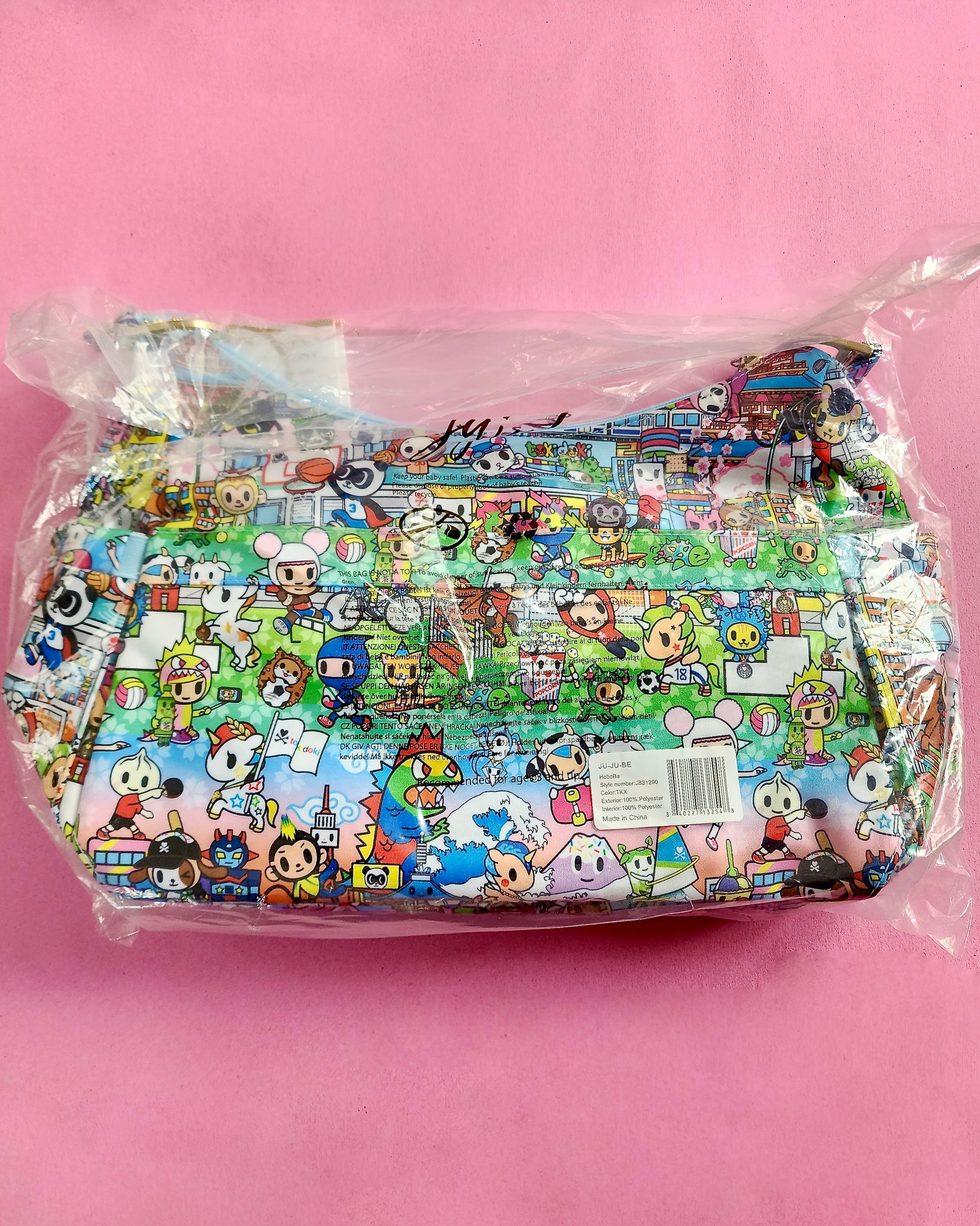 Cartoon character-themed product in clear packaging on a pink background