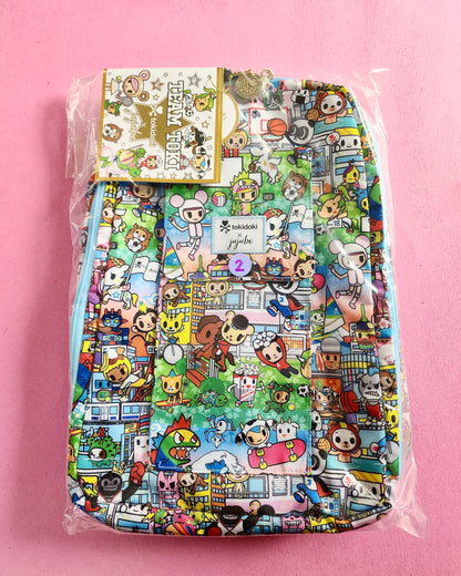 Colorful backpack with cartoon character pattern on a pink background