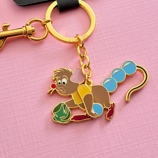 Keychain with mouse character and with beads on tail on pink background