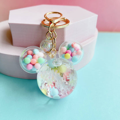 Mouse Head Shaped Keychain with colorful beads and gold accents on a light blue background