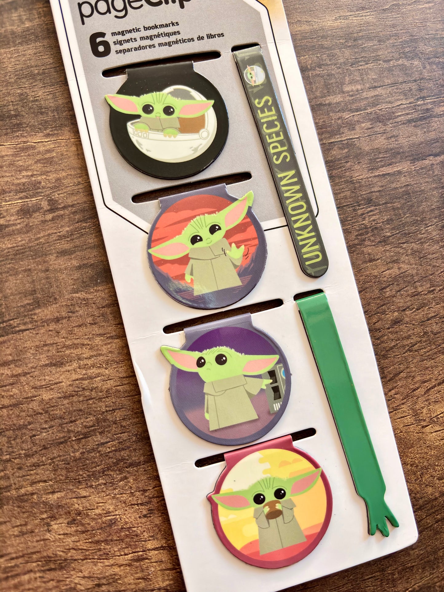 Set of 'Baby Yoda' themed magnetic bookmarks on a wooden surface