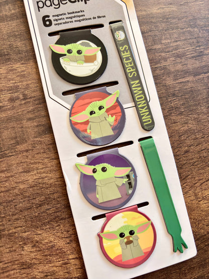 Set of 'Baby Yoda' themed magnetic bookmarks on a wooden surface