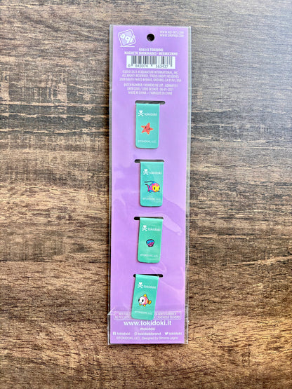 back of packaging of four small green bookmarks with colorful designs on a purple background.