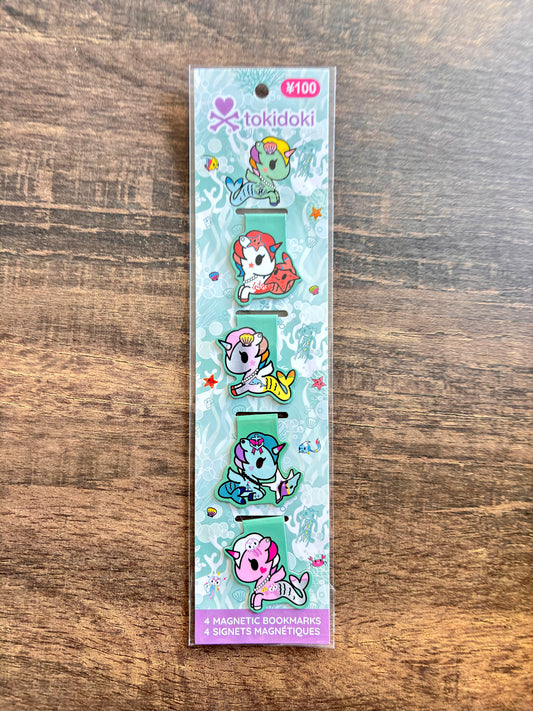 Pack of tokidoki magnetic bookmarks on a wooden surface
