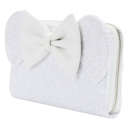 White sequined clutch with a large bow on a white background in wedding or bridal theme