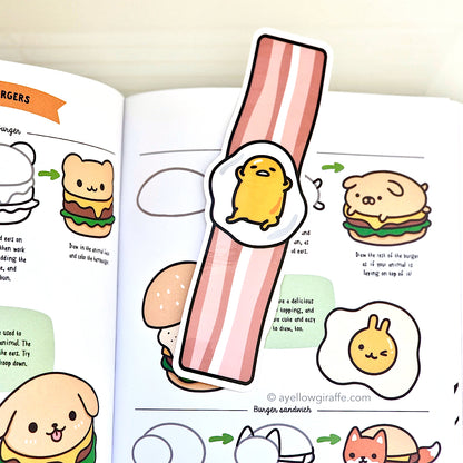 Gudetama fried egg on bacon strip bookmark inside book