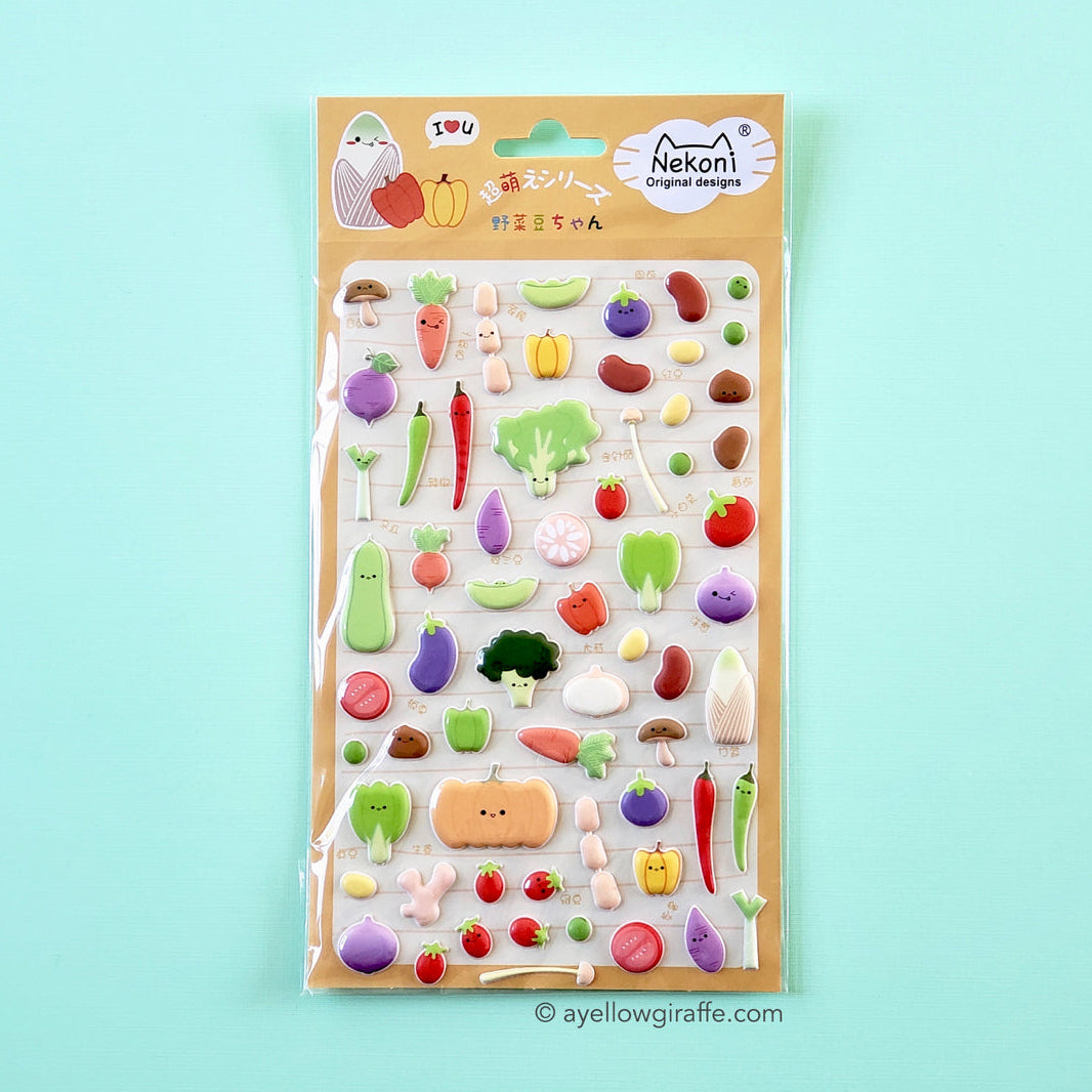 sheet of colorful puffy vegetable stickers on green background