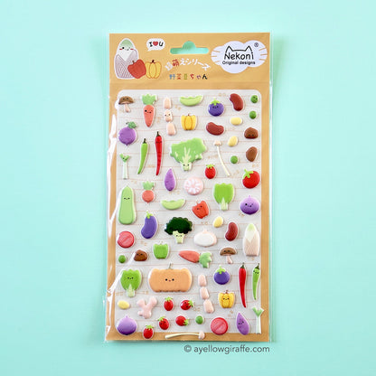 sheet of colorful puffy vegetable stickers on green background