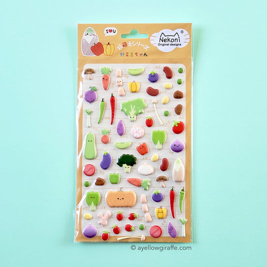 sheet of colorful puffy vegetable stickers on green background